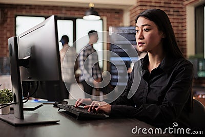 Asian software developer working with html script on terminal window Stock Photo