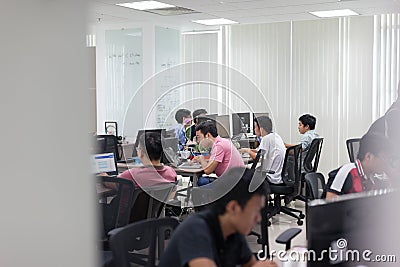 Asian Software Developers Office Team Sitting At Desk Stock Photo