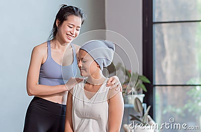 Asian sportive trainer coaching cancer patient to do exercise Stock Photo