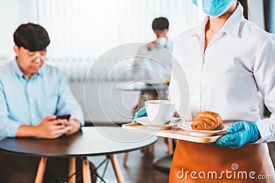 Asian staff restaurant waitress wear protective face mask working in the restaurant social distancing protect infection from Stock Photo