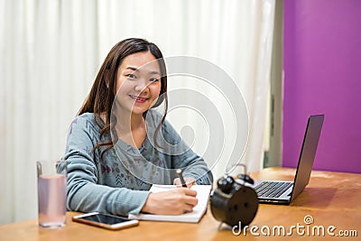 Asian student read and take note in book Stock Photo