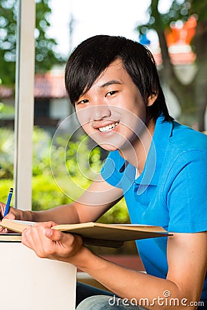 Asian student reading book or textbook learning Stock Photo