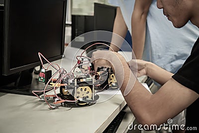 Asian Student thinking and learning STEM Education robotics for creating project based studying for innovation robot model. Study Stock Photo