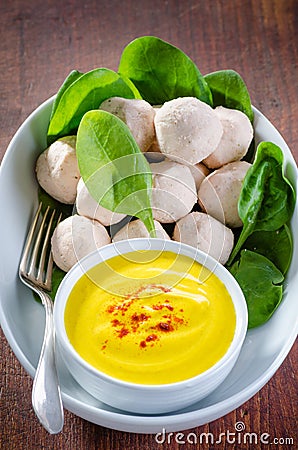 Asian style meatballs in a bowl with saffron and yogurt sauce Stock Photo