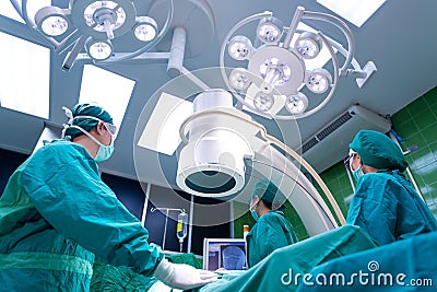 Asian surgeons team working with Monitoring of patient in surgical operating room Stock Photo