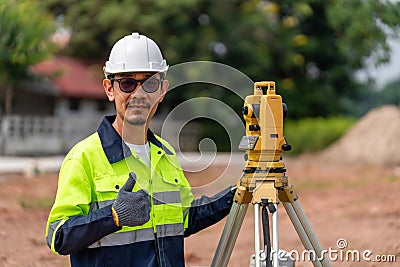 Asian Surveyor Civil Engineer thumbs up with equipment on the construction site Stock Photo