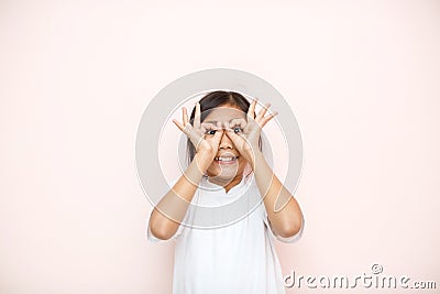 Asian tanned skin girl child portrait over pink wall background Stock Photo