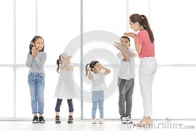 Asian teacher play girls and boy some acting Stock Photo