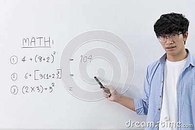 Asian teachers are teaching mathematics classes in addition, subtraction, multiplication, and division in high school or universit Stock Photo