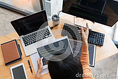 .Asian team Outsource Developer Looking Screen Programming Code Working with Laptop Computer Software Stock Photo