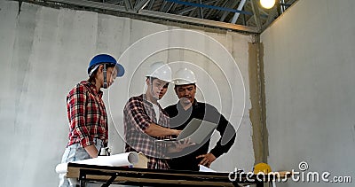 Asian team of young man and woman engineer and architects meeting Stock Photo