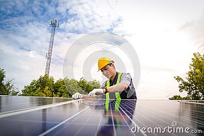 Asian technicians install panels Solar cells to produce and distribute electricity. Stock Photo