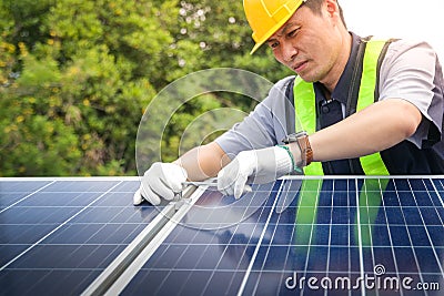 Asian technicians install panels Solar cells to produce and distribute electricity. Stock Photo