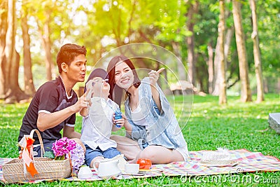 Asian teen family one kid happy holiday picnic moment in the park Stock Photo