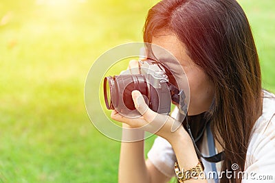 Asian teen using mirrorless digital camera Stock Photo