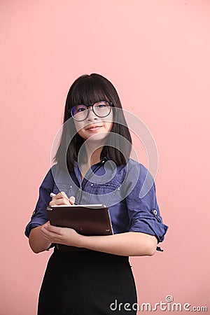 Asian teen writing tablet Stock Photo