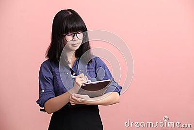 Asian teen writing tablet Stock Photo