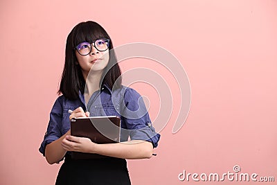 Asian teen writing tablet Stock Photo