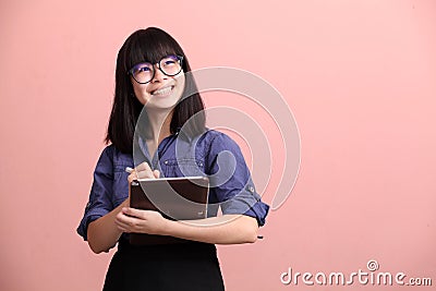 Asian teen writing tablet Stock Photo