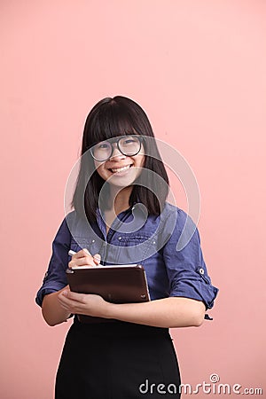 Asian teen writing tablet Stock Photo