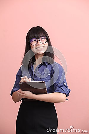 Asian teen writing tablet Stock Photo