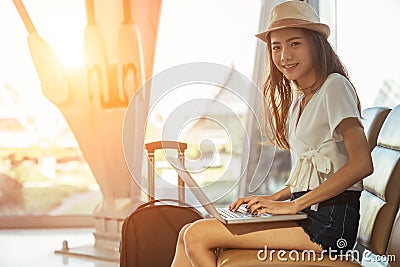 Asian teenage girl is using a laptop to check email or social network Stock Photo