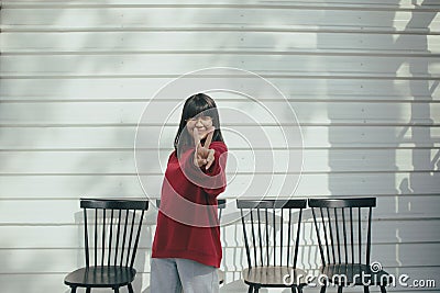 Asian teenager hand sign victory symbol with happiness face Stock Photo