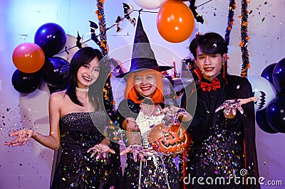 Asian Teenagers in Halloween Costumes Looking Camera, Invite For Enchanting Halloween Season Celebrations. Halloween Haunt Party Stock Photo