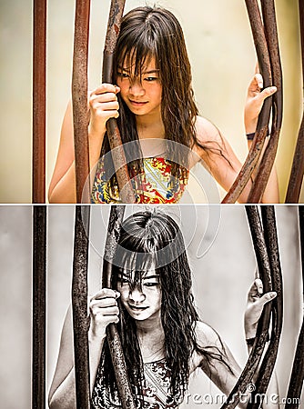 Asian Thai girl is bending the prison bar with her power in grun Stock Photo