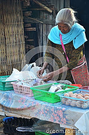 Asian thai old woman people sale food and salt at Ban Bo Kluea village Editorial Stock Photo