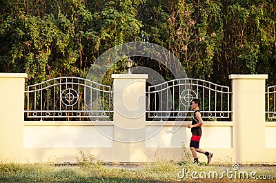 Asian thai people running jogging and exercise in dusk time at public garden park in Nonthaburi, Thailand. Editorial Stock Photo