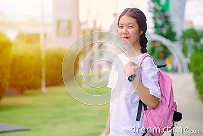 Asian Thai teenager school girl with education bag standing outdoor happy and smile Stock Photo