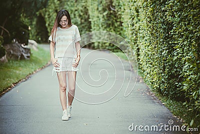 Asian thin hipster girl wearing sunglasses walking smiling Stock Photo