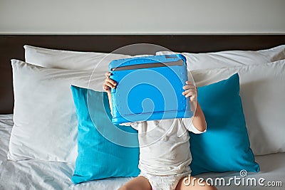 Asian toddler baby boy child watching a video from tablet pc. Kids playing with tablet computer Stock Photo