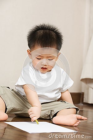 Asian toddler busy drawing Stock Photo