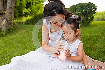 asian toddler kid drinking tasty milkshake Stock Photo