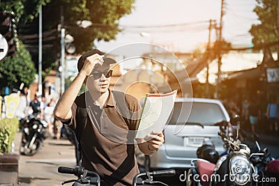 Asian tourist man in a city using bicycle Stock Photo