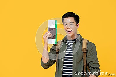 Asian tourist man smiling and holding passport with boarding pass Stock Photo