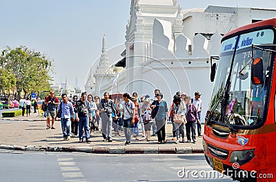 Asian tourist walking follow guide across the street in Bangkok, Thailand Editorial Stock Photo