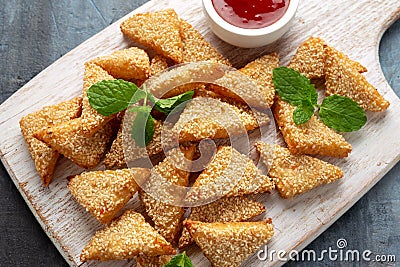 Asian Traditional Prawn Toast with Sesame seeds and sweet chilli sauce on wooden white board Stock Photo