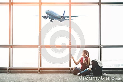 Asian traveler woman using smart phone and drinking coffee in airport for travel in holiday summer. Stock Photo