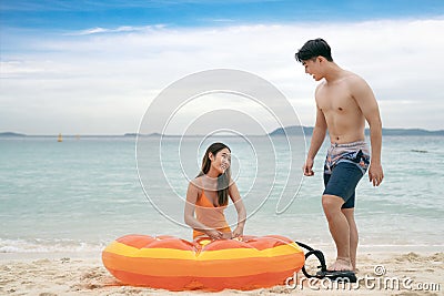 Asian traveller couple playing and sweet togather on the beach between honeymoon day at Phi phi island maya beach Stock Photo