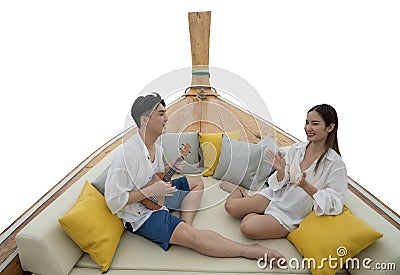 Asian traveller couple sit togather on the traditional wooded long tail boat head between sea travel trip to Phi phi island Stock Photo