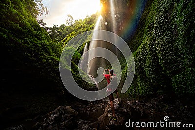 Asian traveller take photo in Madakaripura Water fall Stock Photo