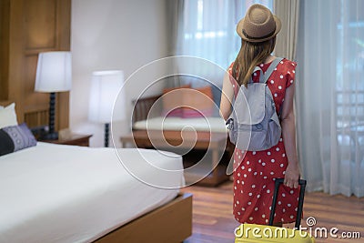 Asian traveller woman check in and open the door in Hotel room between her traveller trip Stock Photo