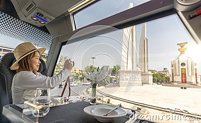 Asian traveller woman take a photo the Thailand democracy monument Stock Photo