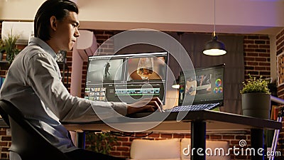 Asian videographer designing video montage on editing software Stock Photo