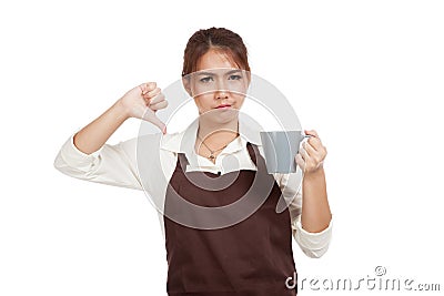 Asian waitress in apron thumbs down with cup of coffee Stock Photo