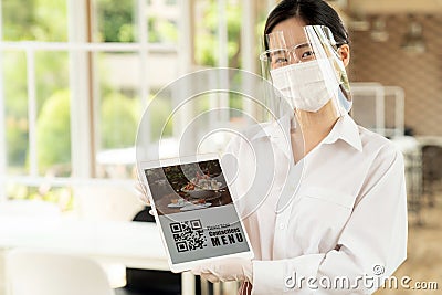 New Normal asian waitress hold qr code contactless menu tablet Stock Photo