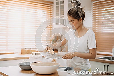 Wife cooking and prepare noodle meal for husband in the kitchen. Stock Photo